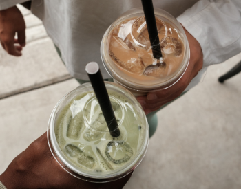 holding cold drink cups with cold beverages inside