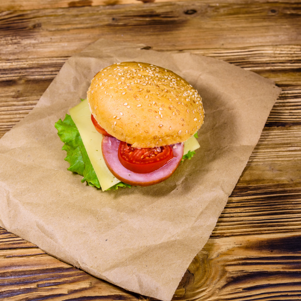 a burger placed atop a brown paper liner