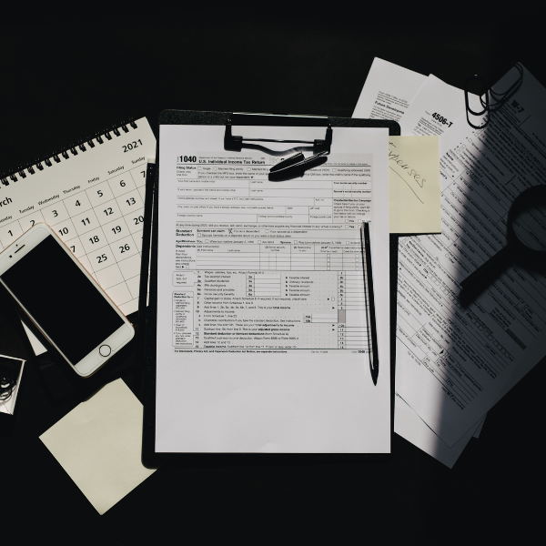writing pad, papers, calendars, and a phone