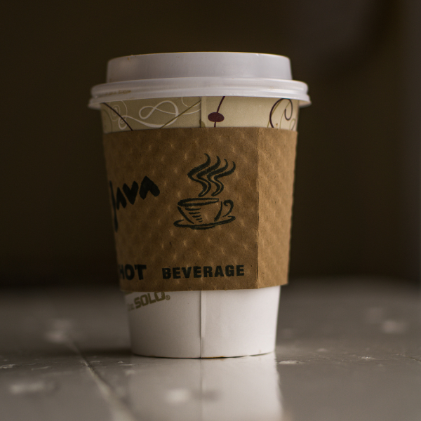 a coffee cup with sleeve on it