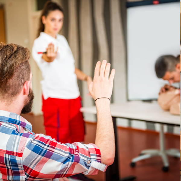 a man raising his hand to ask a question