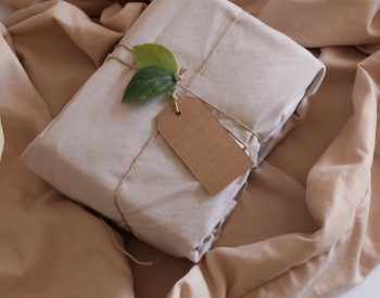 a packaged parcel with a label and a leaf
