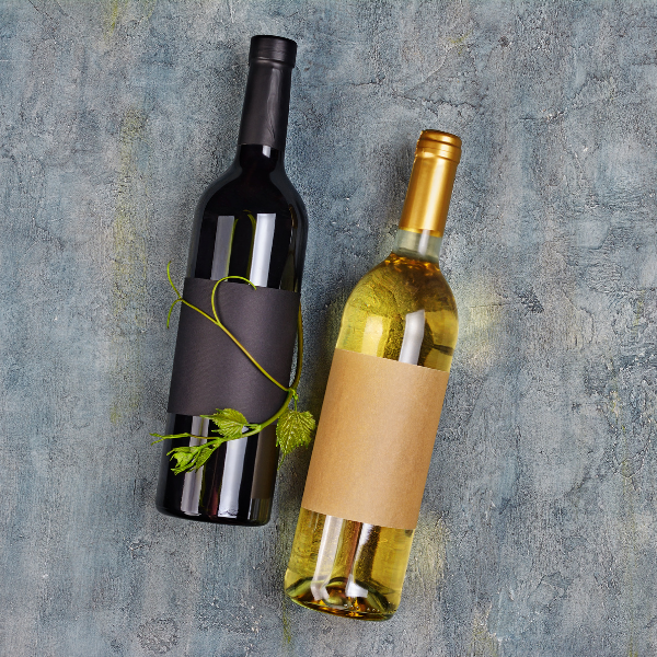  two wine bottles—one black and one plain—against a textured grey background. Both bottles have blank labels.